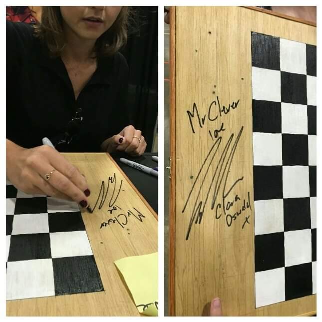 Jenna signing chessboard